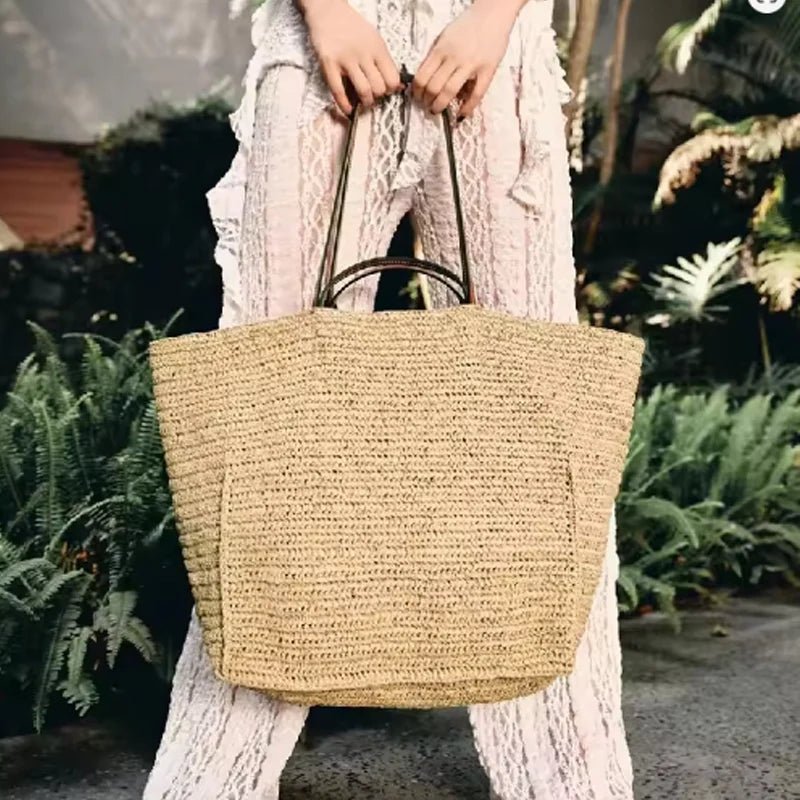 Aimee Handwoven Straw Tote Bag in Dark Brown, carried by model