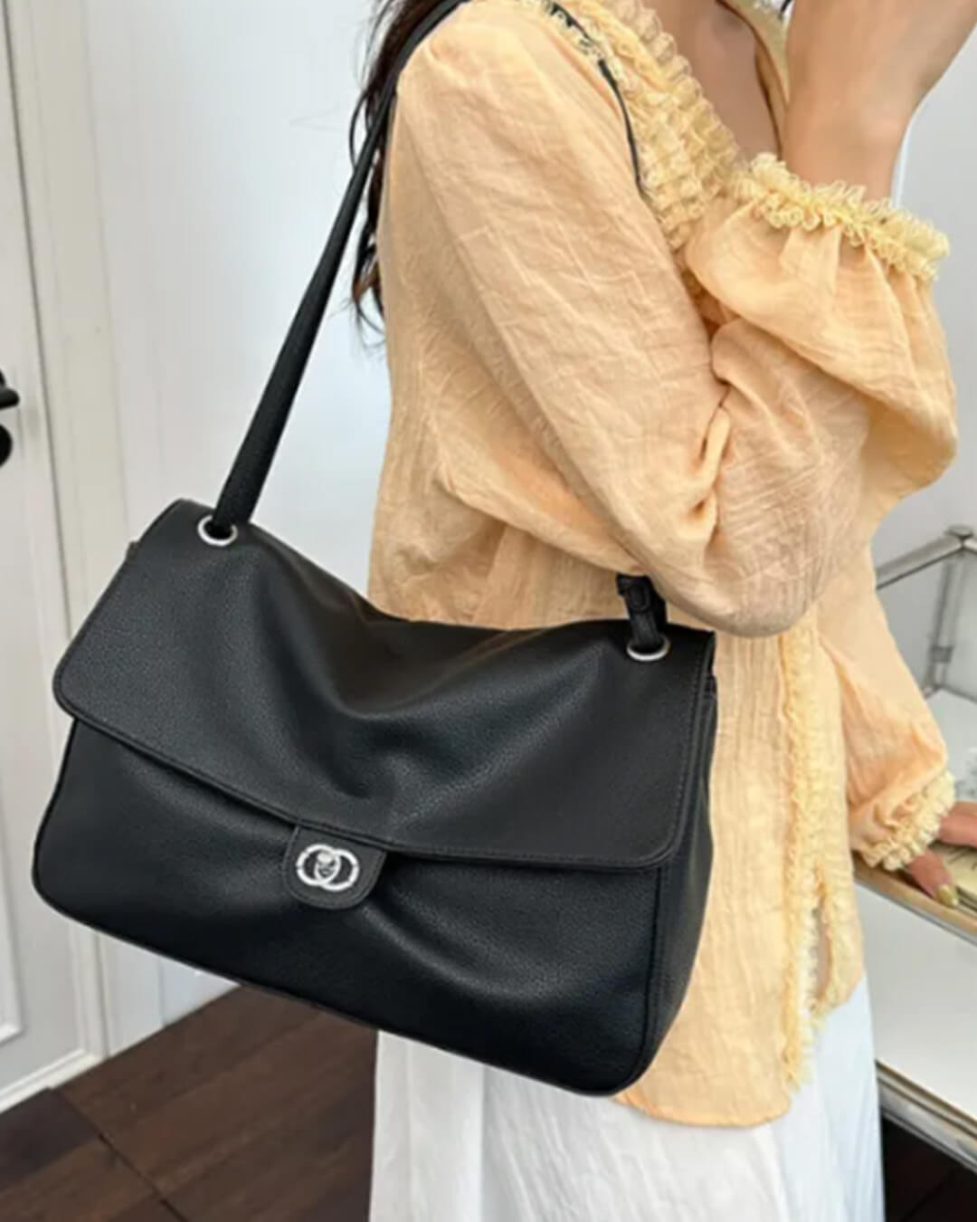 Solveig Buckle Flap Shoulder Bag in black – styled look